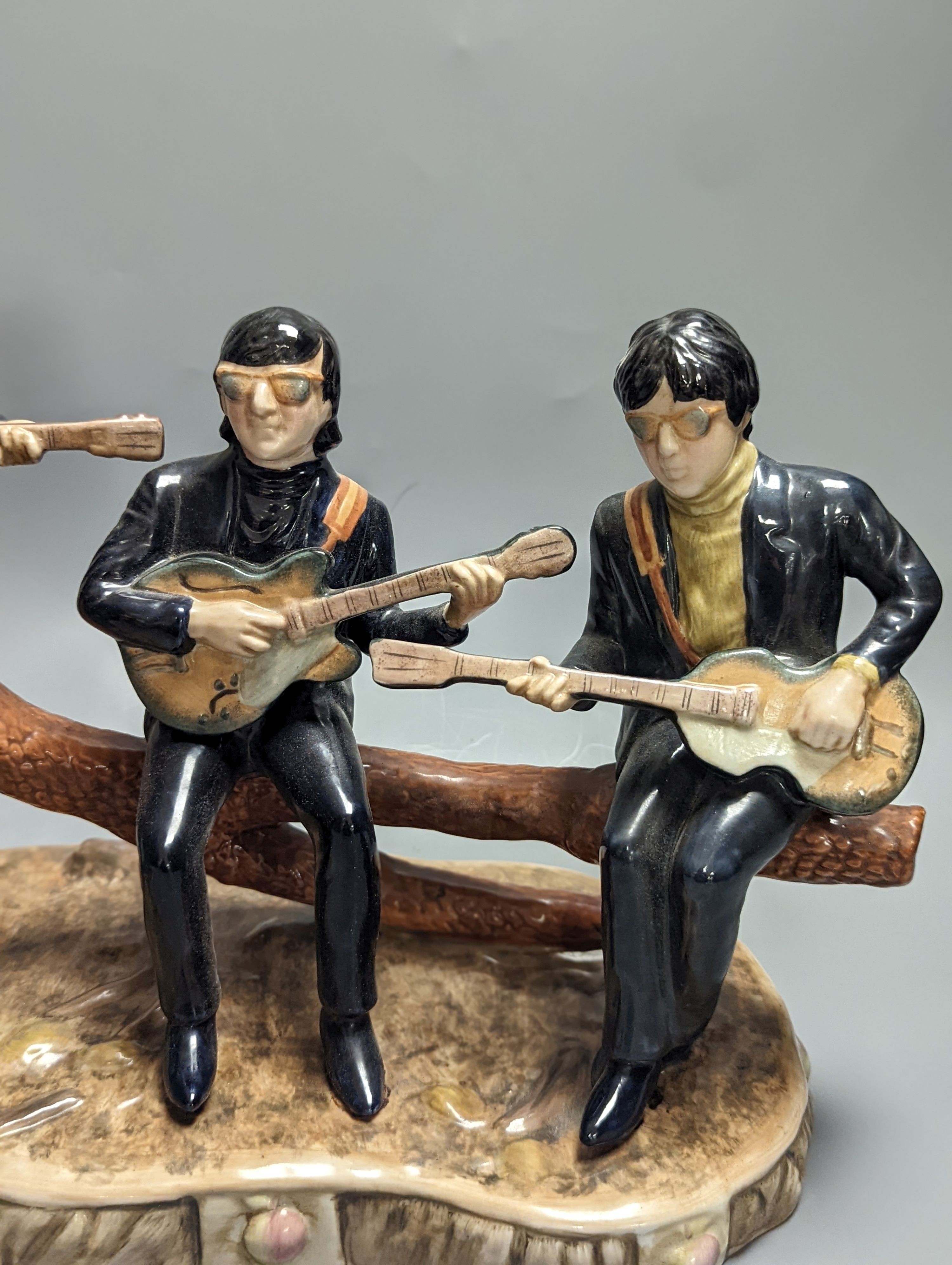 A large pottery figure group The Legends of Rock & Roll, The Beatles at Hyde Park 37cm long